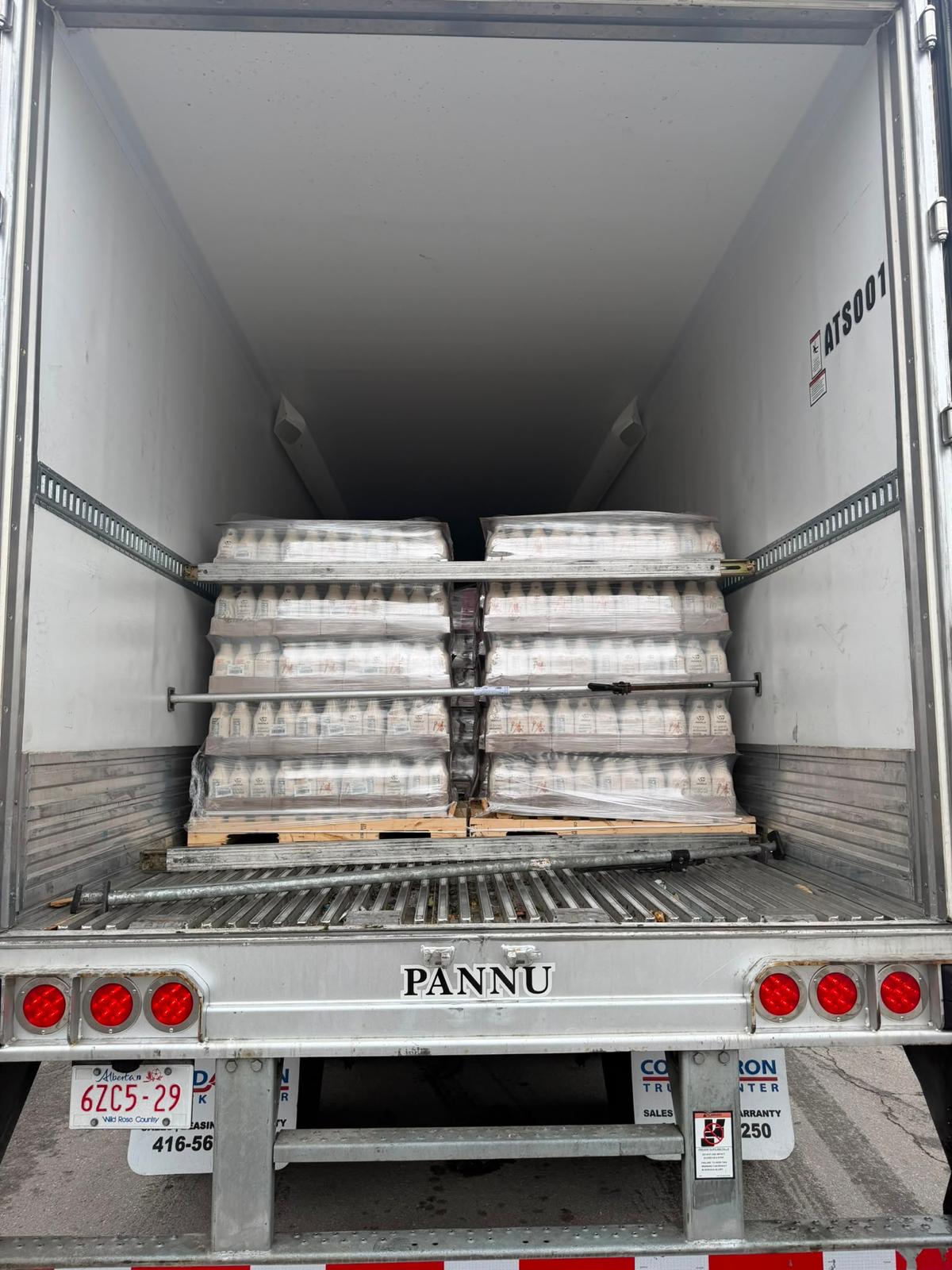 Pallets of dairy product cases in a refrigerated trailer