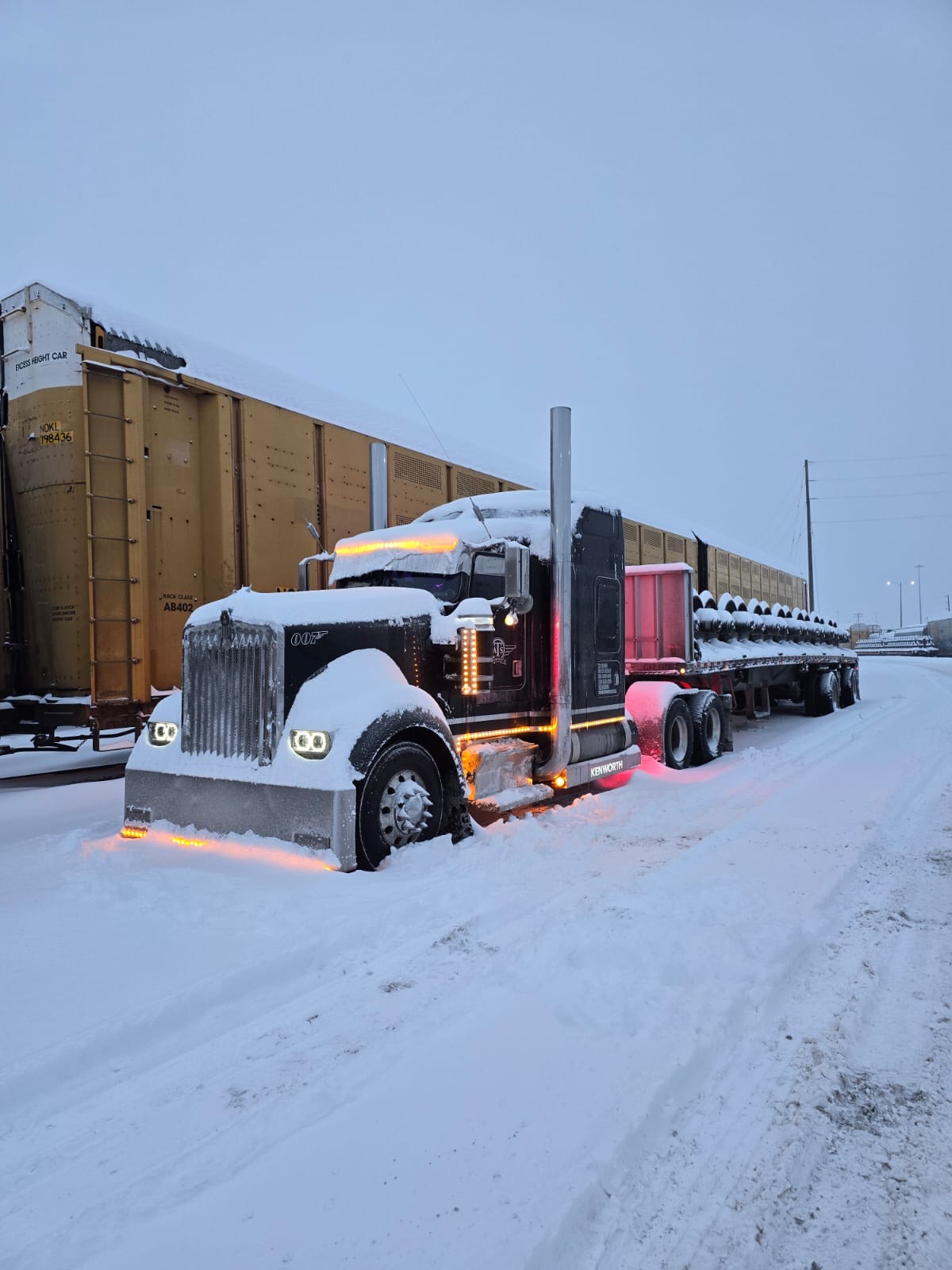 Flatbed loaded with steel coils in winter